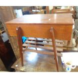 A 62cm mid 20th Century teak sewing box with part fitted interior and slatted undertier, set on