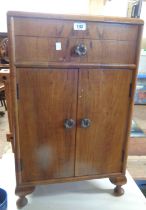 An early 20th Century walnut veneered bedside cabinet with lift-top, single drawer and double