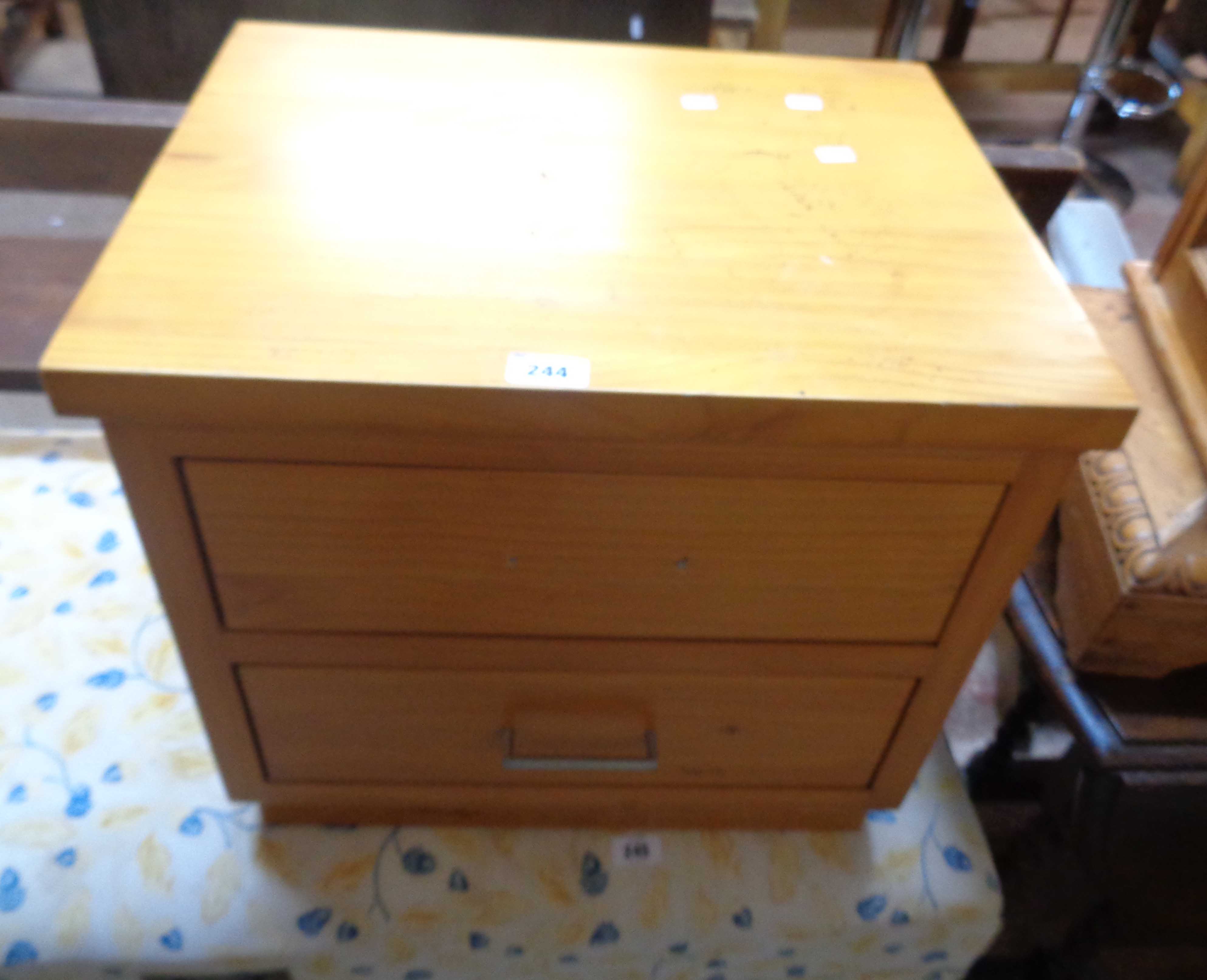 A modern mixed wood two drawer bedside chest