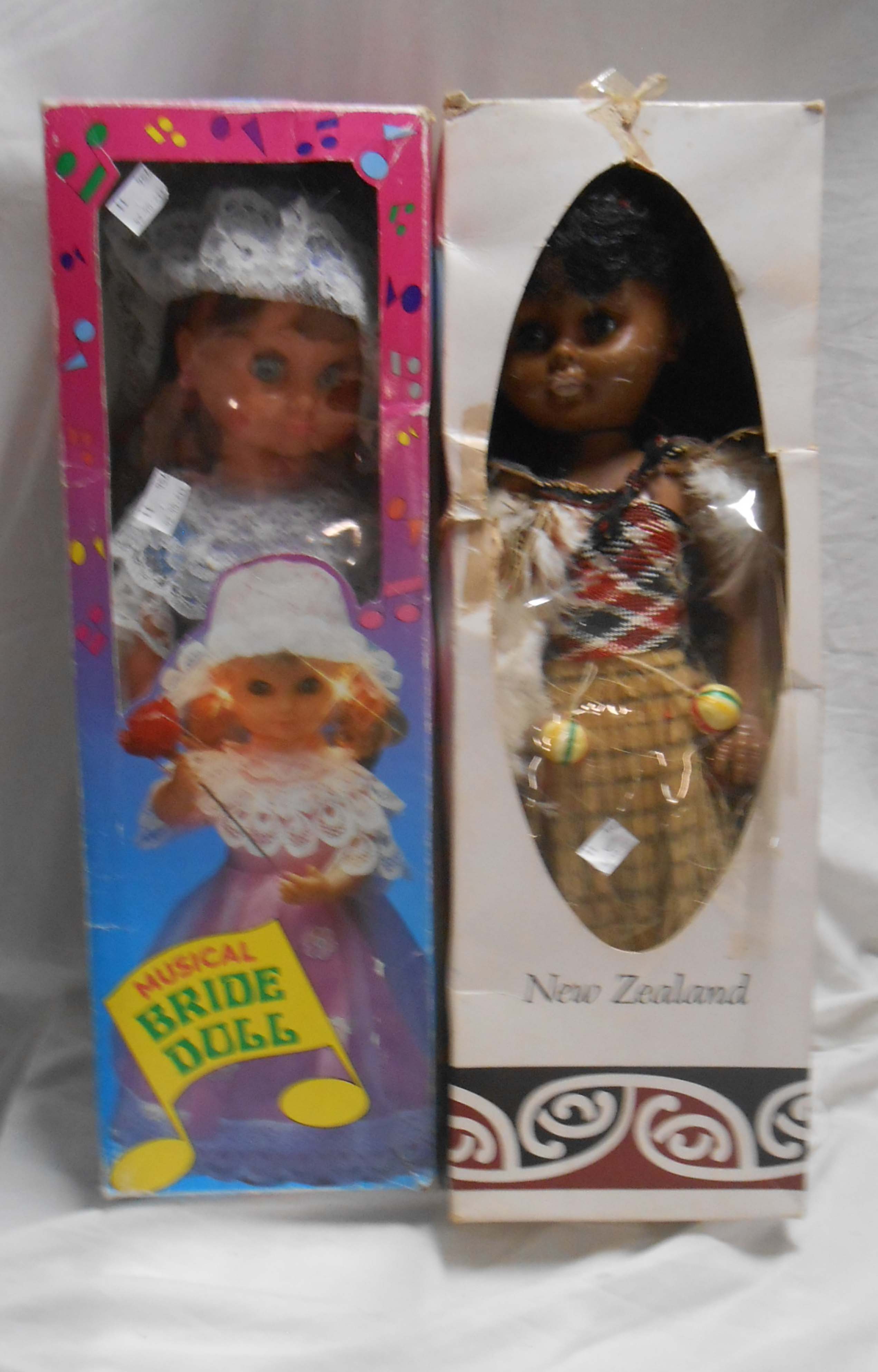 Two vintage boxed dolls comprising a musical bride doll and a New Zealand Maori doll