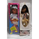 Two vintage boxed dolls comprising a musical bride doll and a New Zealand Maori doll