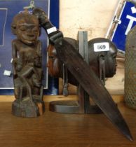 A pair of Tanzanian carved wood bookends, tree of life figure and letter opener