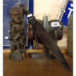 A pair of Tanzanian carved wood bookends, tree of life figure and letter opener