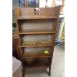 A 59cm Arts & Crafts oak four shelf open bookcase with pierced decoration to top, set on shaped