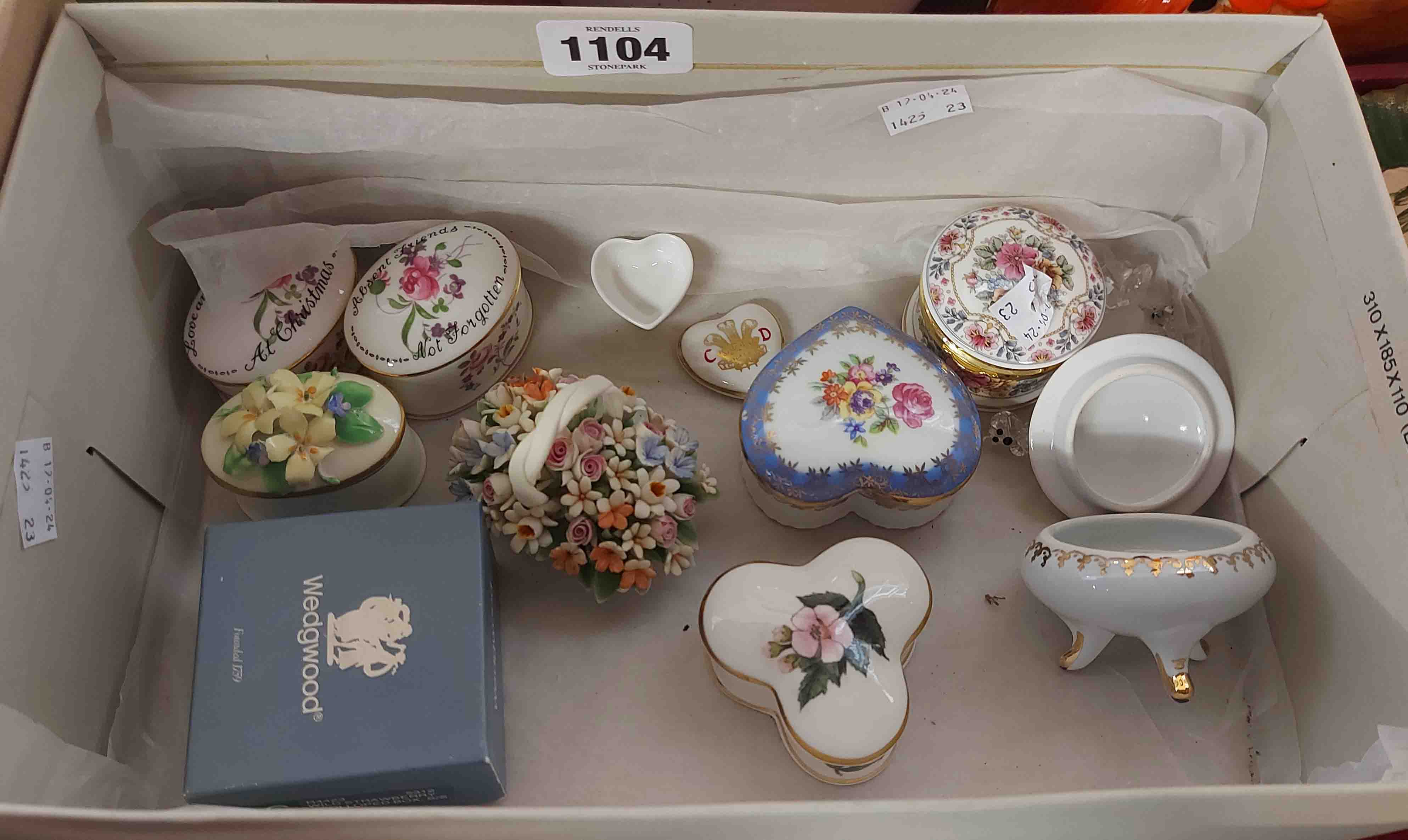 A box containing a quantity of ceramic trinket boxes of various form and maker