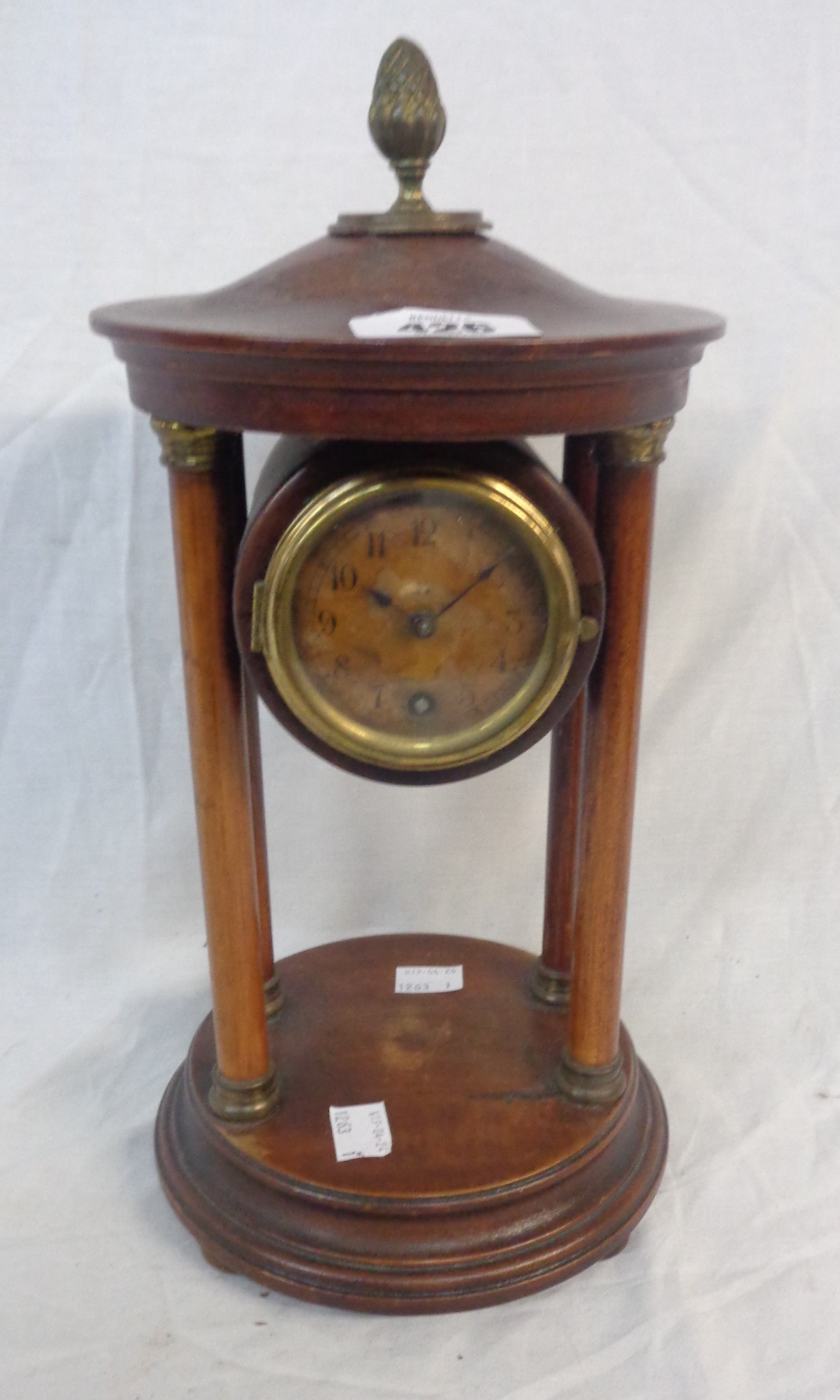 A late Victorian mixed wood portico table timepiece with simple mechanical movement - dial stained