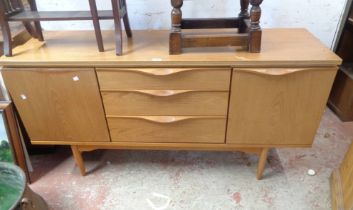 A 1.53m retro teak effect sideboard with three central drawers and flanking cupboards, set on