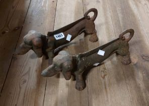 A pair of cast iron boot scrapers of dachshund form