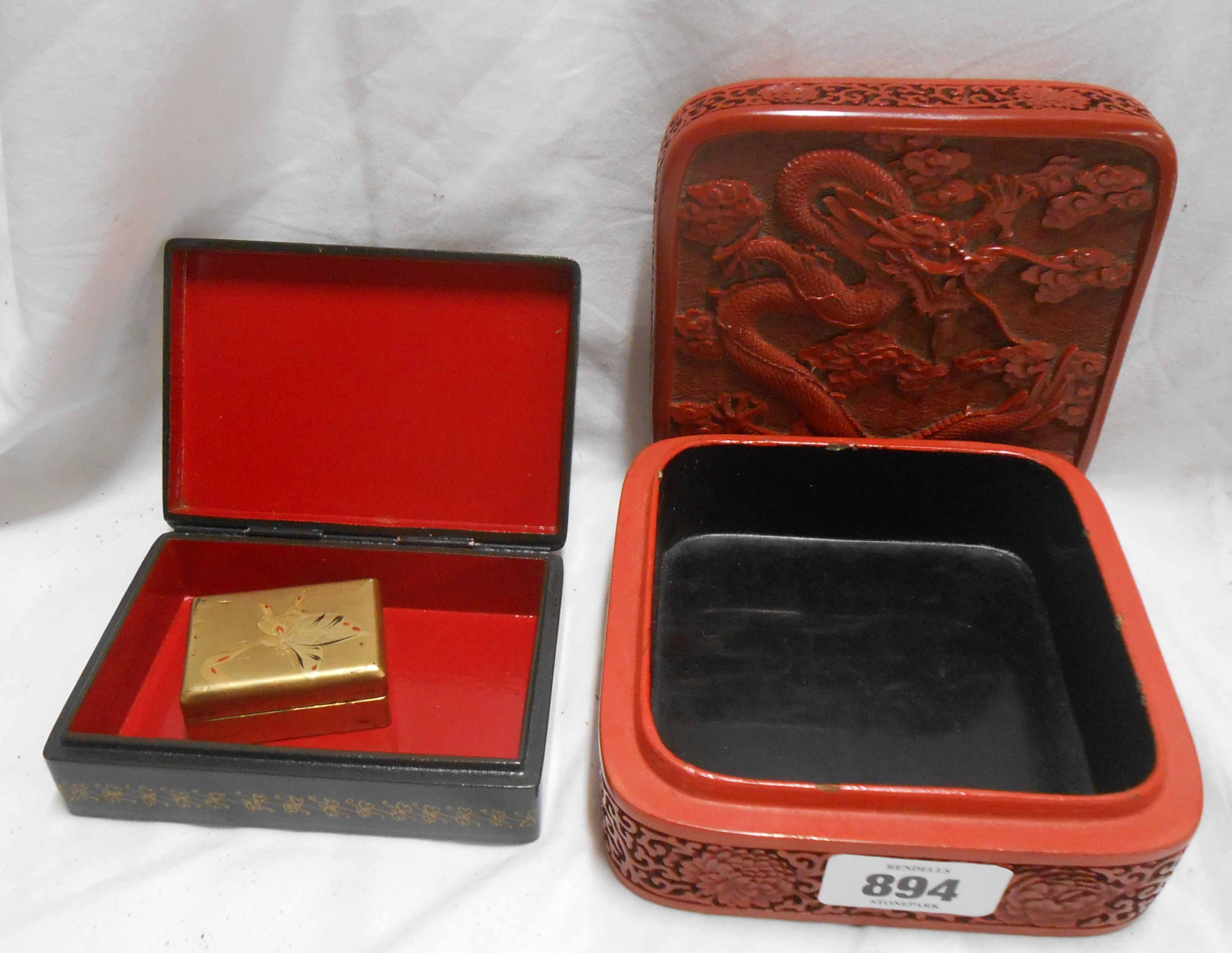 A red lacquered Chinese trinket box - sold with a Russian trinket box and a small gold lacquered