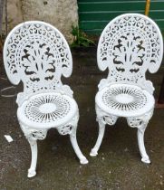 Two white painted cast iron garden chairs