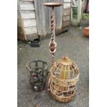 An antique bird feeder, shaped candlestick and iron potholder