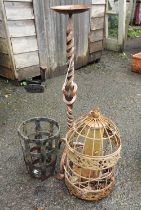 An antique bird feeder, shaped candlestick and iron potholder