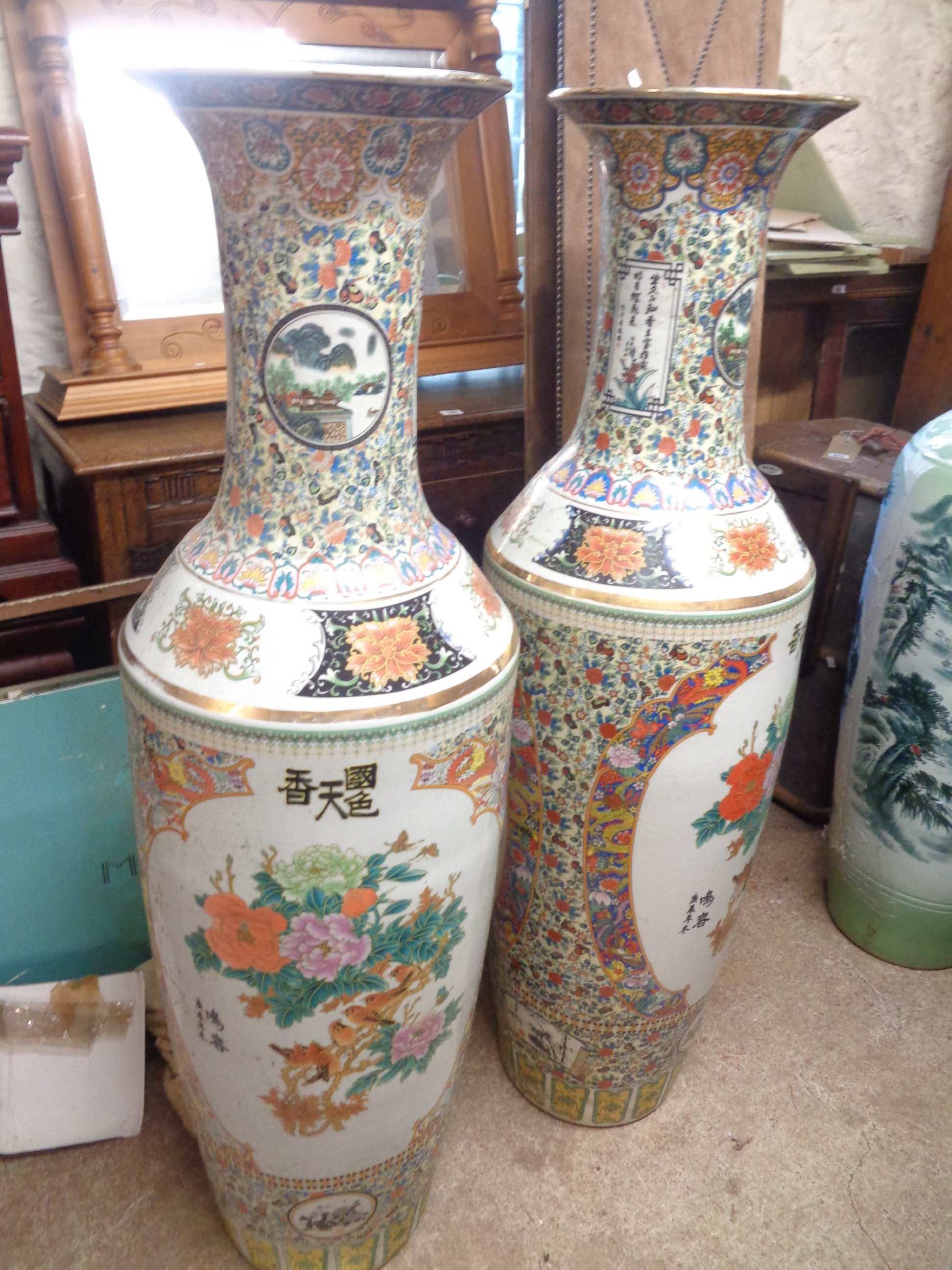 A pair of very large 20th Century Chinese porcelain vases with floral and trellis decoration on a