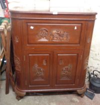 An 80cm modern Chinese carved hardwood bow front cocktail cabinet with lift-top opening to reveal
