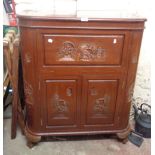 An 80cm modern Chinese carved hardwood bow front cocktail cabinet with lift-top opening to reveal