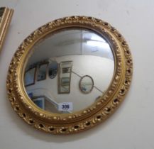 A small gilt framed convex wall mirror with decorative border