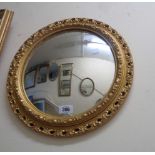 A small gilt framed convex wall mirror with decorative border