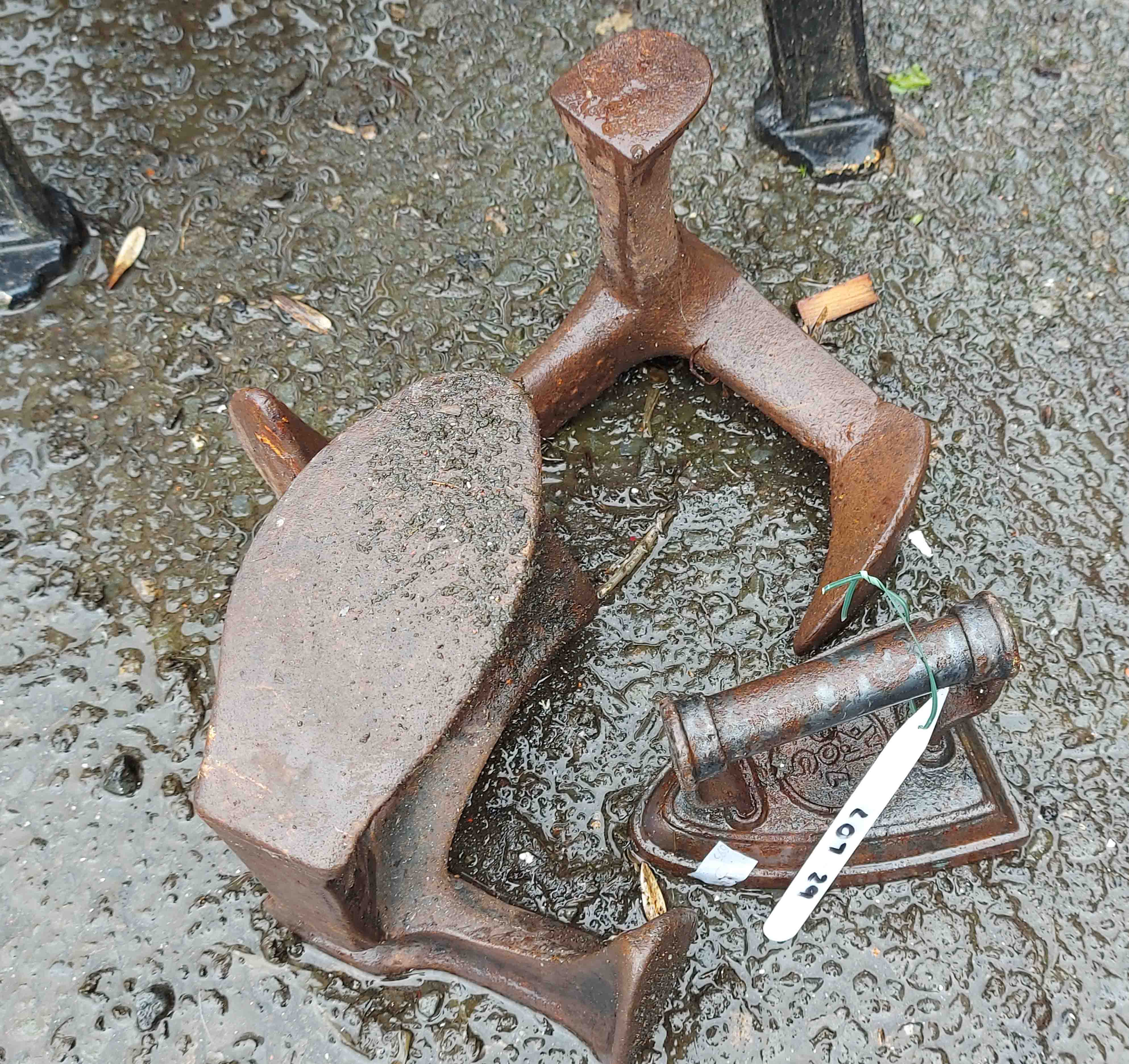 A pair of old iron shoe lasts - sold with a flat iron