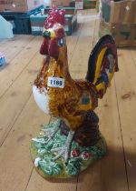 A large Portuguese pottery cockerel figurine painted in vibrant colours