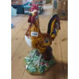 A large Portuguese pottery cockerel figurine painted in vibrant colours