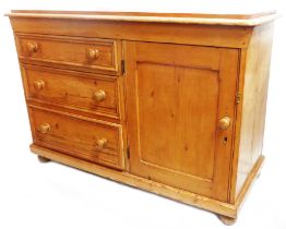 A 1.2m Victorian pine cupboard with panelled door to one side and three long graduated drawers to
