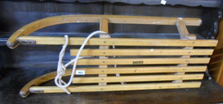 A vintage wooden sledge marked Davos