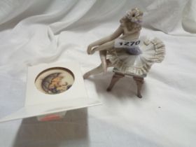 A Lladro porcelain figurine, depicting a seated ballerina - sold with a small boxed Hummel
