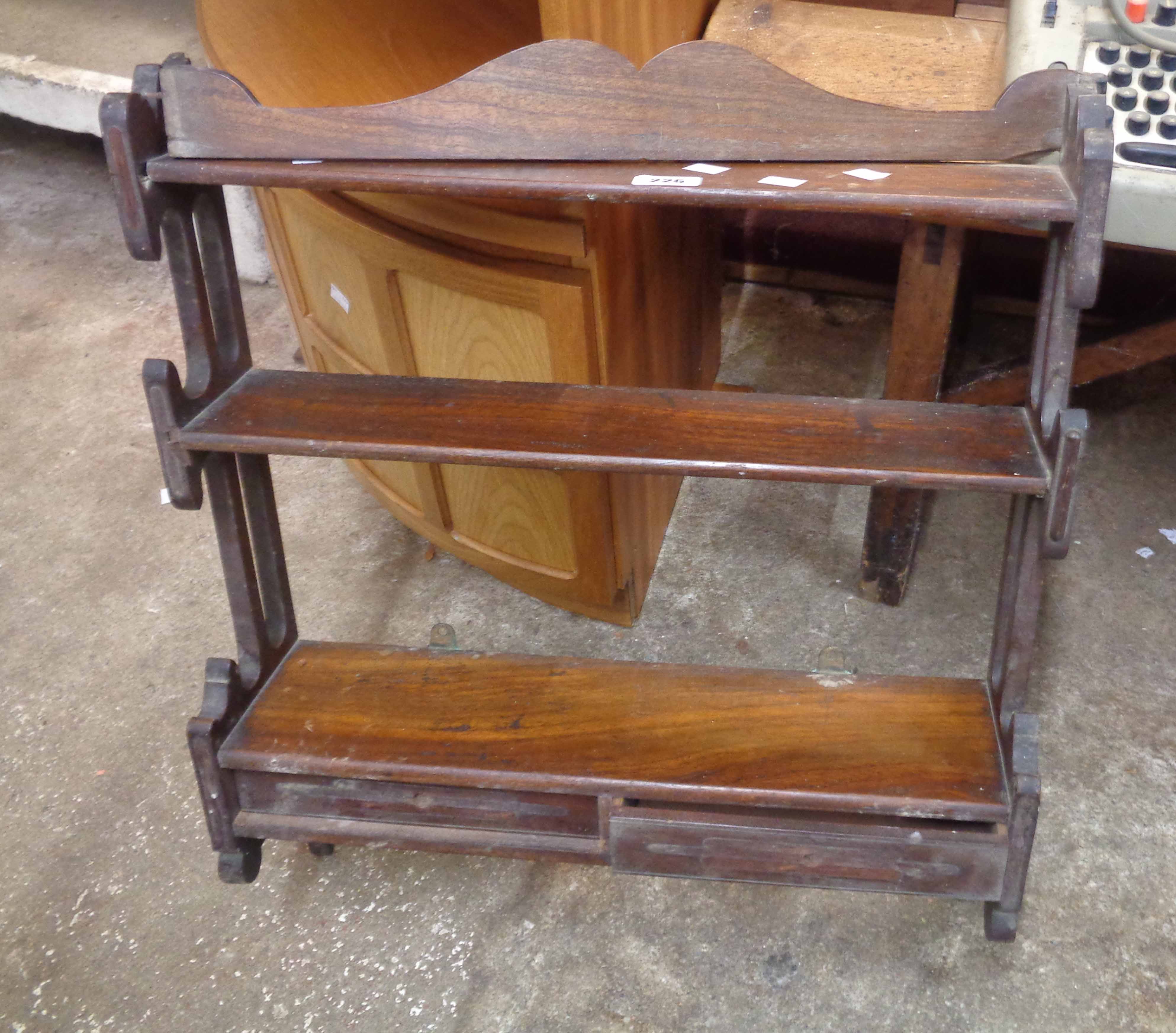 A 57cm antique mahogany three tier waterfall open shelf unit with pierced sides and two drawers