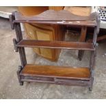 A 57cm antique mahogany three tier waterfall open shelf unit with pierced sides and two drawers