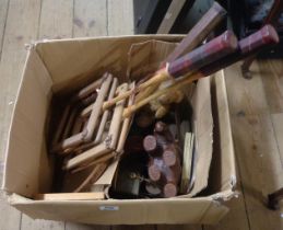 A box containing various collectable items including badminton rackets (for restringing), a small