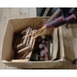 A box containing various collectable items including badminton rackets (for restringing), a small