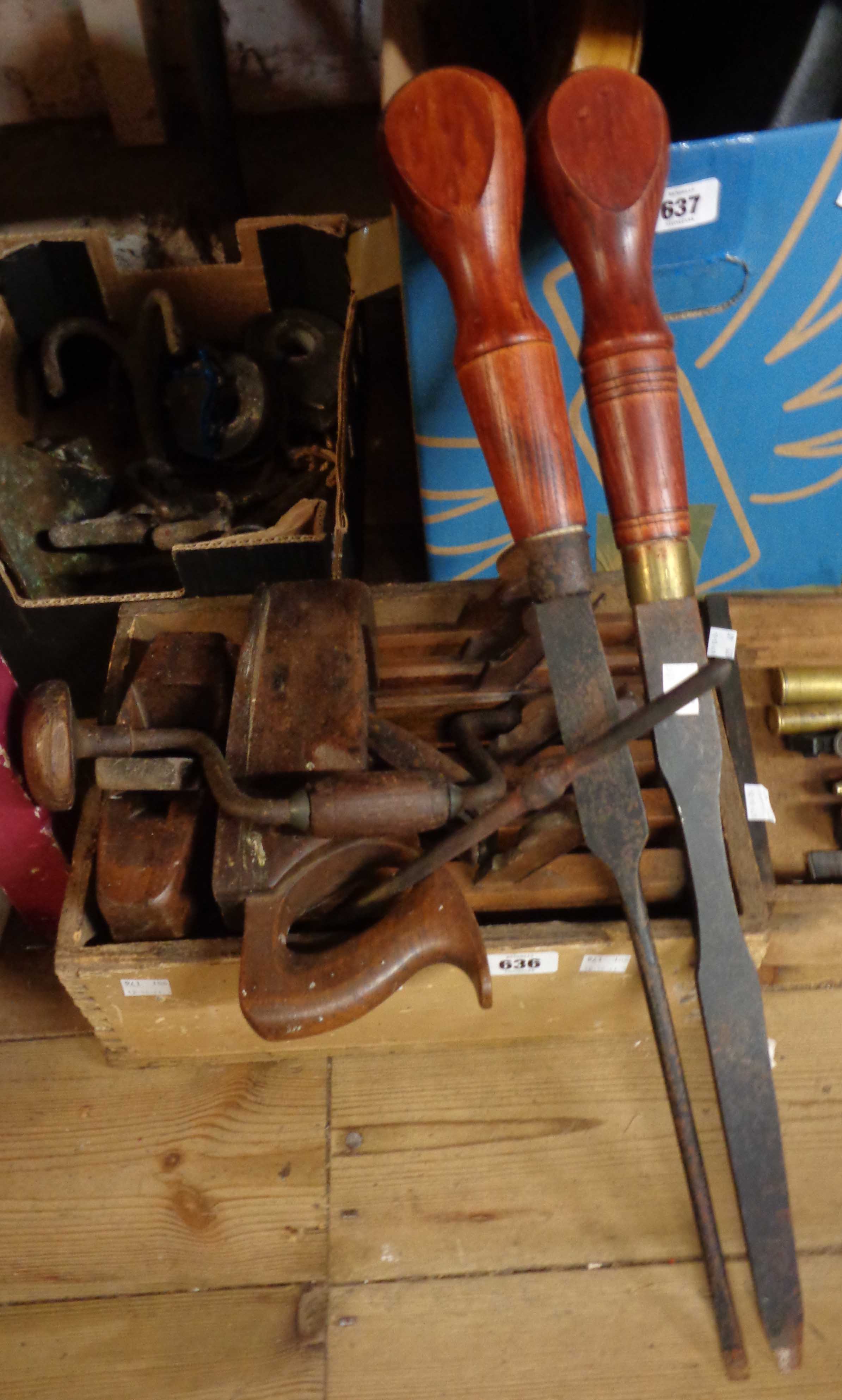 A wooden box containing planes and other woodworking tools - sold with a quantity of hand saws