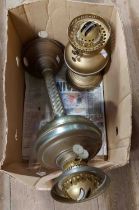 A vintage brass oil lamp of pillar form - sold with another smaller brass oil lamp