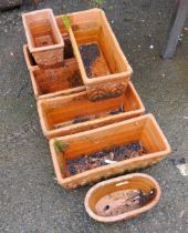 Six rectangular planters - sold with one smaller similar and a circular planter