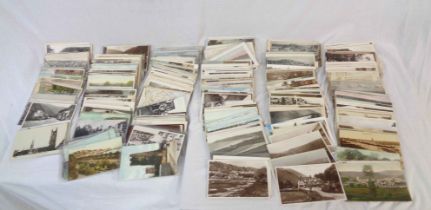 A box containing a collection of early 20th Century and other Devon interest postcards including