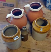 Two slip decorated terracotta milk jugs - sold with two stoneware jars and a similar bottle