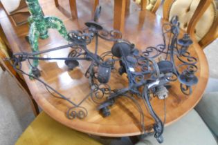 Four vintage wrought iron hanging lights with electrical fittings - sold with a similar wall sconce