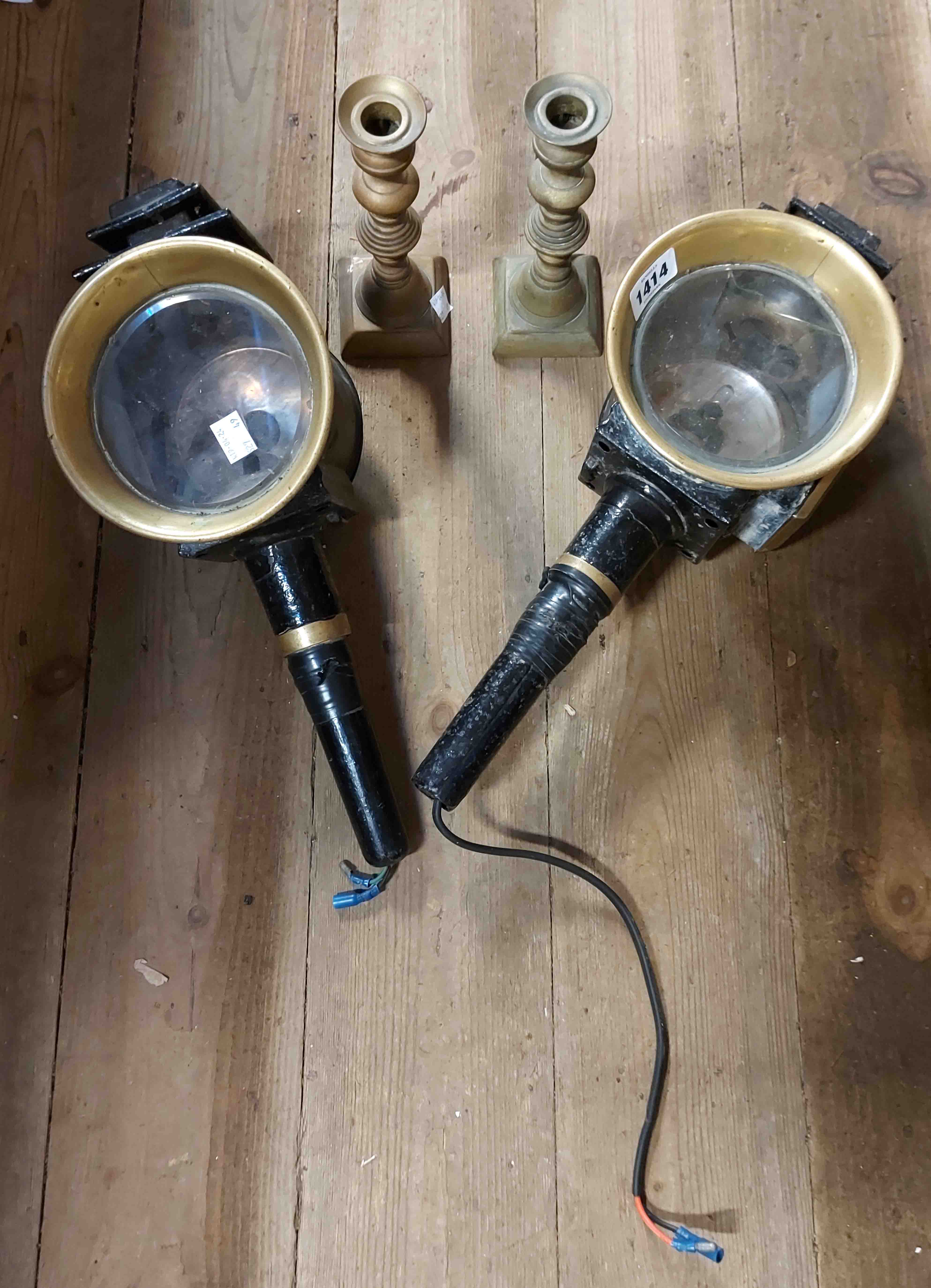 A pair of old coach lamps with black painted body and brass fittings, converted to electric - one