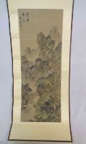 A 20th Century rolled Chinese scroll with painted textile panel, depicting a mountain landscape -