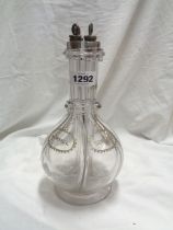 An early 20th Century glass four part liqueur decanter, made for Humphrey Taylor of London, with