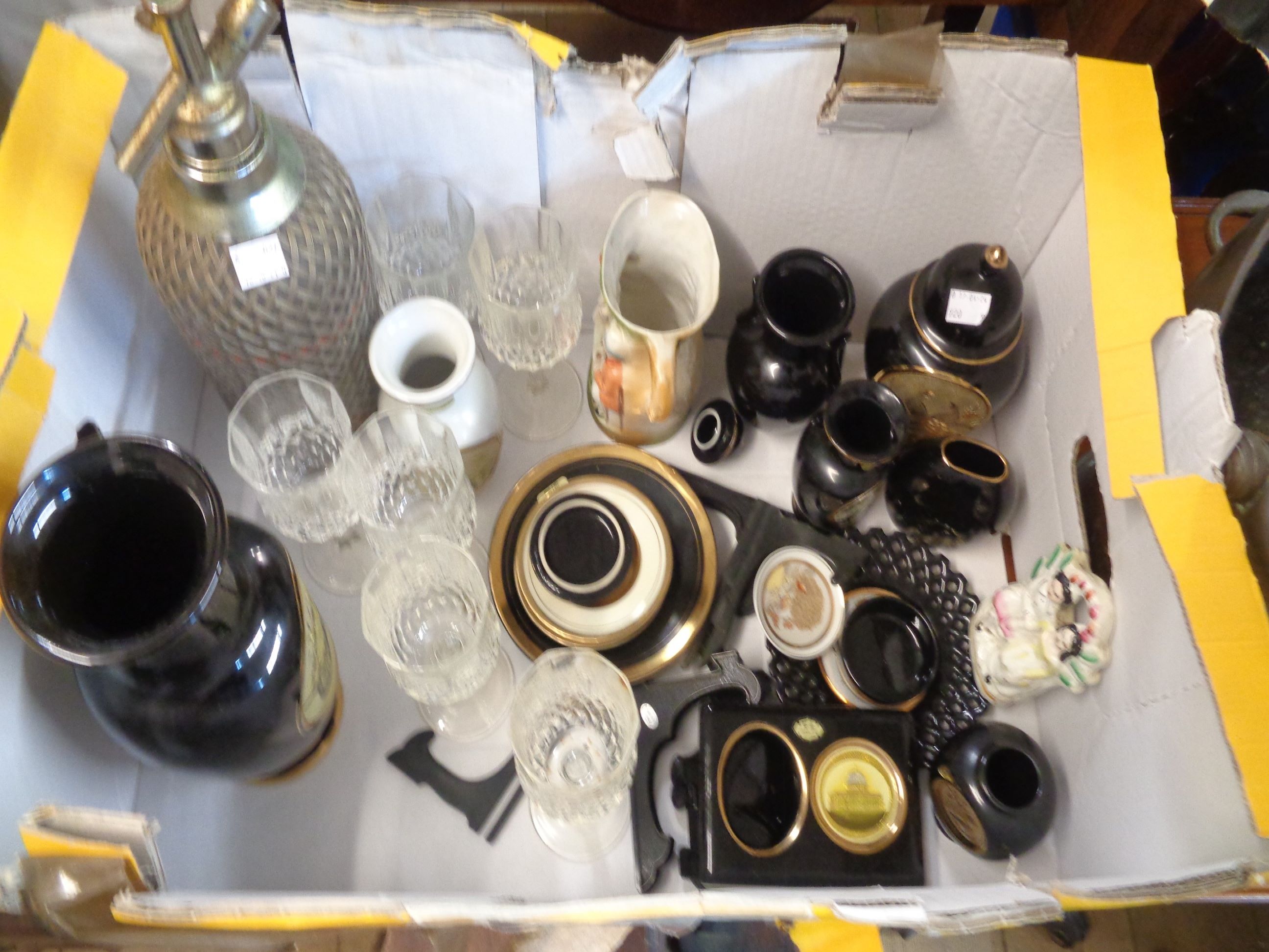 A box containing a quantity of ceramics and other collectable items including an old soda syphon,