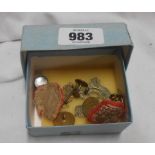 A small box containing military pins and buttons including Kings African Rifles cap badge, etc.