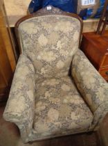 A 1920's style carved oak part show frame armchair with machine tapestry upholstery