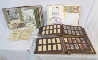 A box containing a Victorian cabinet album containing 20th Century mainly religious scraps and