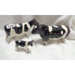 A Beswick pottery Friesian cattle family comprising bull, cow and calf