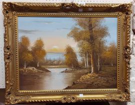 †Chapman: an ornate gilt framed oil on canvas, depicting a woodland river landscape at sunset -