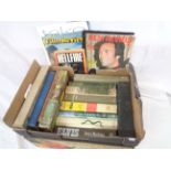 A box containing a selection of assorted hardback books including Rock-n-Roll interest, Dirk Bogarde