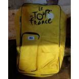 A yellow Tour de France rucksack containing two matching fold-up chairs