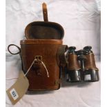 A pair of WWI field glasses set within leather case