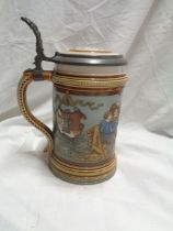 A vintage Villeroy & Boch Mettlach tankard with medieval style frieze decoration and cast metal